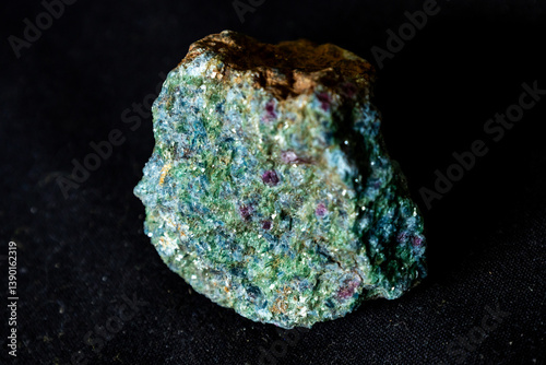 A pistachio green Epidote rock sample with trace of red garnet