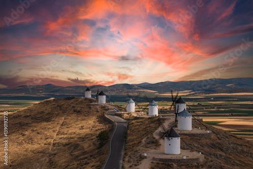 photographs of the sunset next to the consuegra mills in toledo,