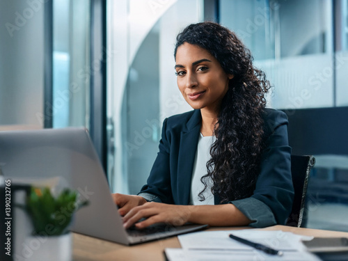 close-up Young professional it specialist latin hispanic business lady working on laptop pc sitting at desk in modern office space. 30s middle eastern indian woman