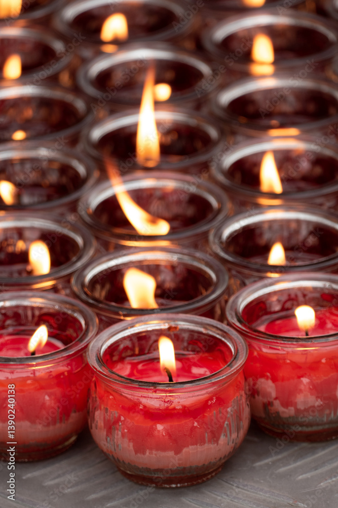 Burning glass of candles in the buddhism temple