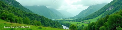 Lush green highlands with mist-covered mountains and a winding river,  scenery,  mist