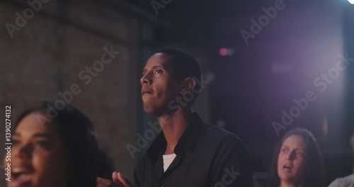 Man clapping in evangelical church worship, Afro-descendant male with joyful expression, black shirt, community celebration of faith, spiritual devotion and praise