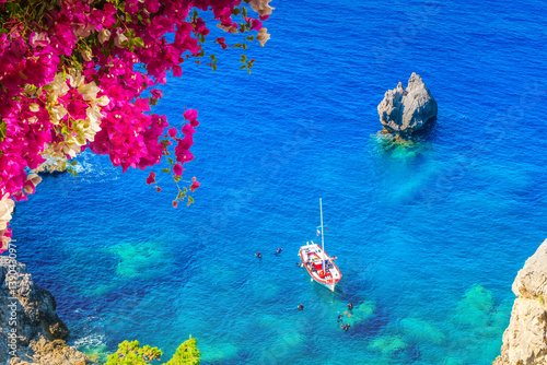 Fototapeta Naklejka Na Ścianę i Meble -  Paleokastritsa beach, small bay and Ionian sea clear water on Corfu, Greece, view from above