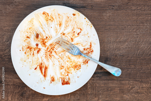 dirty plate after eating.  fork on a plate. Dirty dish after eating.