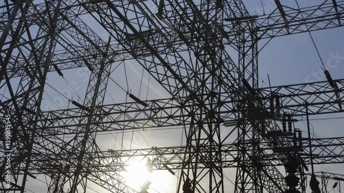 High voltage power lines are prominently displayed at Hoover Dam, capturing the intricate structure against the backdrop of a blue sky in Arizona Nevada.