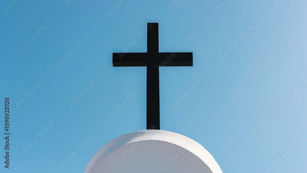 A close-up shot of a church cross under a pristine blue sky A close-up shot of a church cross under a pristine blue sky