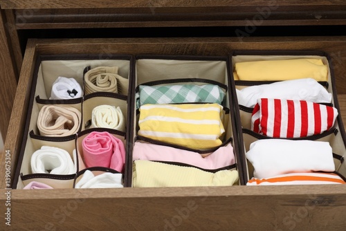 Obraz na płótnie Organizers with folded clothes in drawer indoors, closeup w salonie