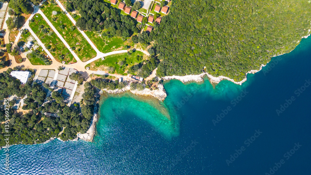 Fototapeta premium Aerial photo of the stunning Limski Kanal and Camping Koversada near Vrsar, Croatia. The landscape features lush greenery, crystal-clear turquoise waters, and winding coastline — a true Adriatic