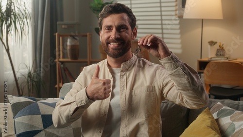 Happy man Caucasian guy showing keys of new home smiling male homeowner buying first apartment real estate invest house mortgage own dwelling rent moving day relocation bank credit purchase thumb up