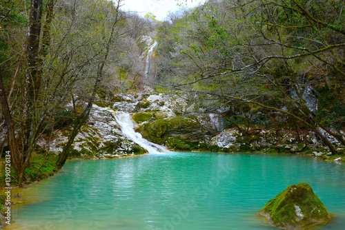 Water flowing into a turquoise colored lake at Buzet canyon in Istria, Croatia