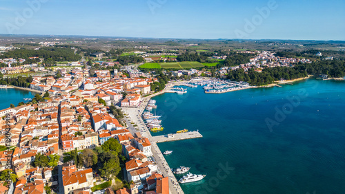 Aerial view of Poreč (Porec), Croatia, showcasing the charming old town, vibrant coastline, and the nearby island of Sveti Nikola. The stunning Zelena Laguna area adds to the beauty turquoise waters