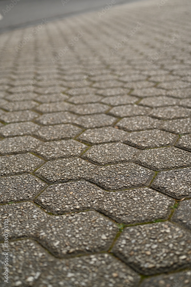 Obraz premium pentagonal grey paving tile texture, grey tile pattern as background, grey tile texture close up tiles as a background in the old town, grey tiles