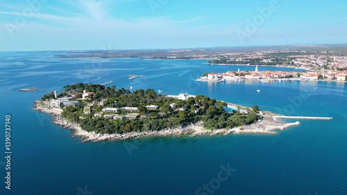 Aerial view of Poreč (Porec), Croatia, showcasing the charming old town, vibrant coastline, and the nearby island of Sveti Nikola. The stunning Zelena Laguna area adds to the beauty turquoise waters