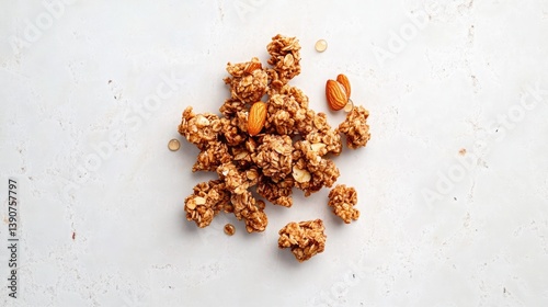 A compact view of irregularly shaped clusters of granola formed with almonds and honey on a pristine white tabletop