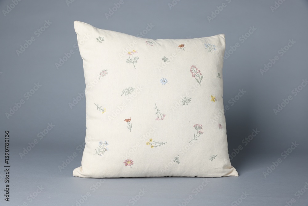One soft decorative pillow on grey background One soft decorative pillow on grey background