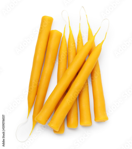 Fotografia Beeswax taper candles isolated on white, top view