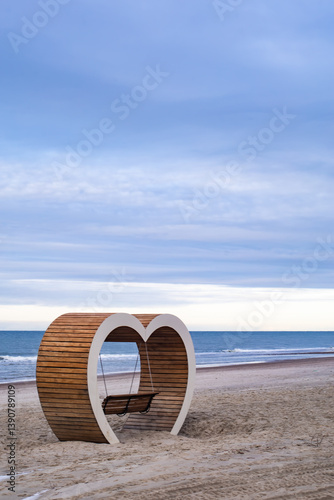 Fototapeta Naklejka Na Ścianę i Meble -  Heart-shaped bench on the Baltic Sea shore, Yantarny village Kaliningrad region Russia