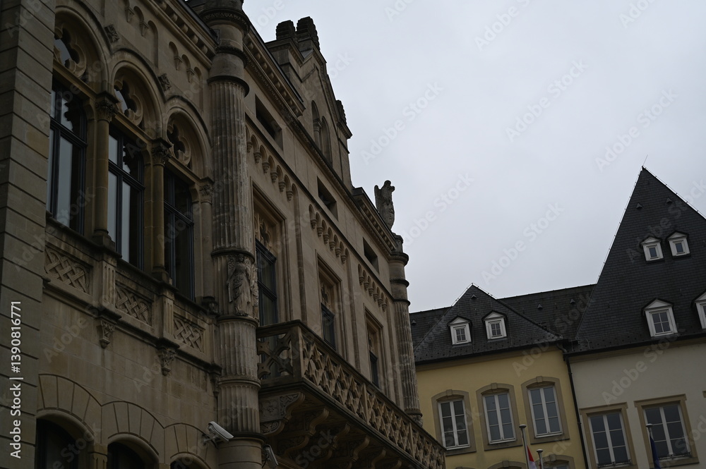 Fototapeta premium Historic European building facade with windows and mansard roof. Classic architecture and urban detail background, Luxembourg or Northern France style.