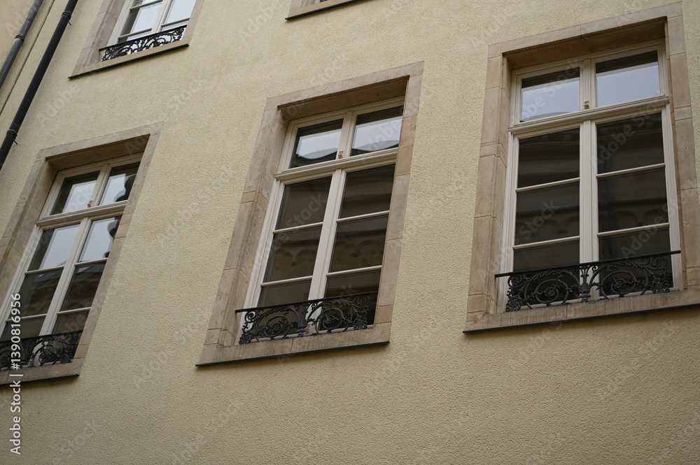 Fototapeta premium Historic European building facade with windows and mansard roof. Classic architecture and urban detail background, Luxembourg or Northern France style.
