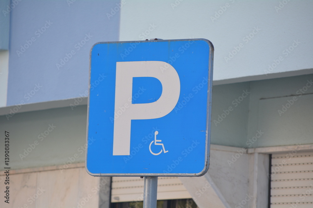 Parking sign indicating accessible parking space in a public area during daylight Parking sign indicating accessible parking space in a public area during daylight
