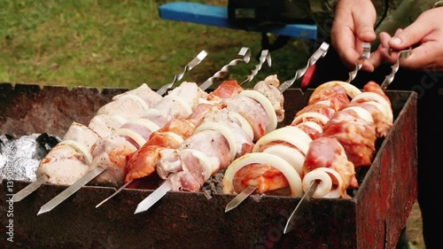 Male hands fry shish kebab on the grill. Healthy food, outdoor food, campfire food.