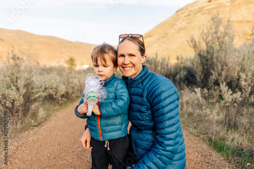 A young toddler enjoys a camping trip with his mother in Oregon.