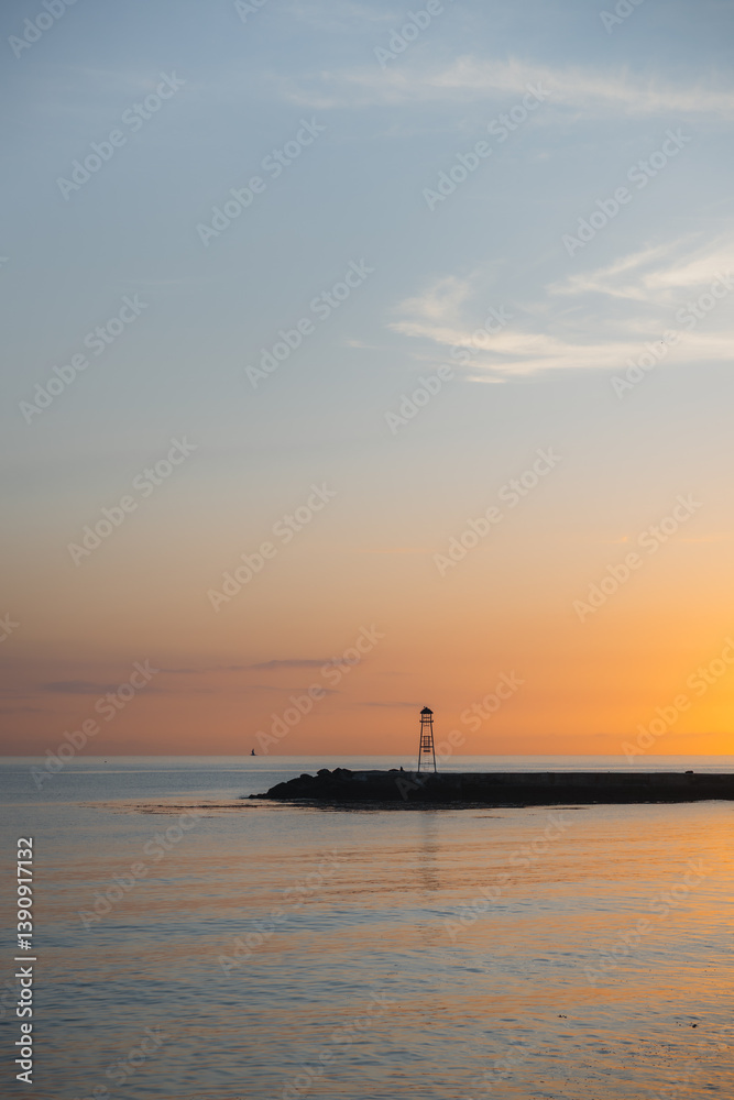 Fototapeta premium A pier in the calm sea at sunset.