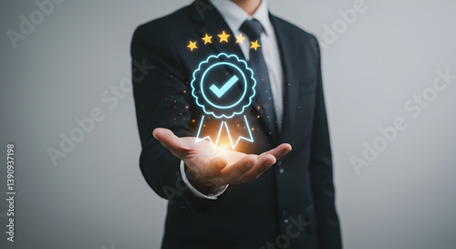 A man in a suit holding a glowing checkmark badge with stars above it on his open hand in a studio