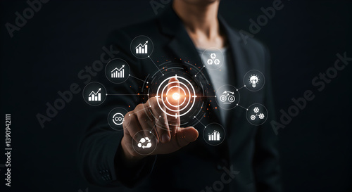 A person pointing at a target with icons around it in a dark setting representing business goals