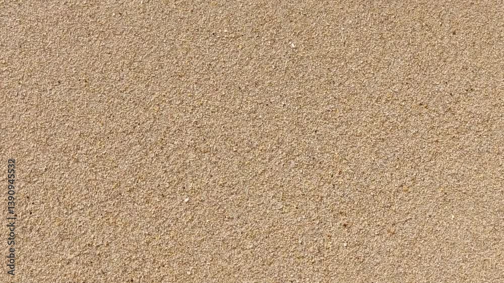 Ocean wave receding on sandy beach. Bubbles and foam create a dynamic texture, great for background or abstract concepts of renewal, cleansing, or summer vibes.