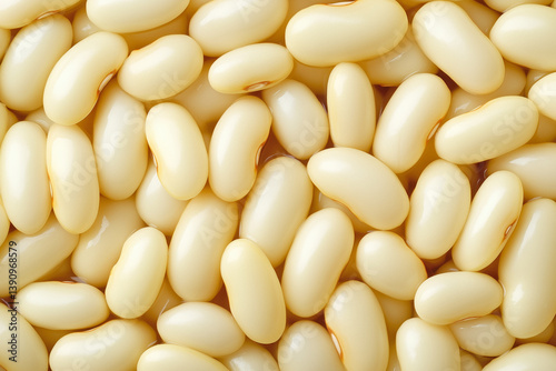 A close-up, top-down view of a pile of smooth, pale beige lima beans.