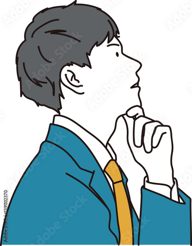上を見上げて考え事をするスーツの男性の横顔