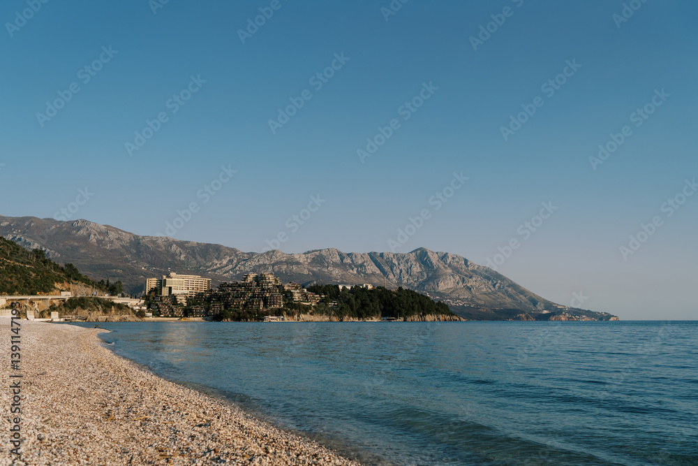 Deserted main beach of Budva overlooking the mountains by the sea. Montenegro Deserted main beach of Budva overlooking the mountains by the sea. Montenegro