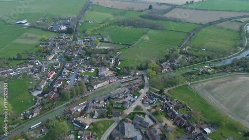Aerial view drone small village with canal river and church sunny day England scenic rural heritage  photo
