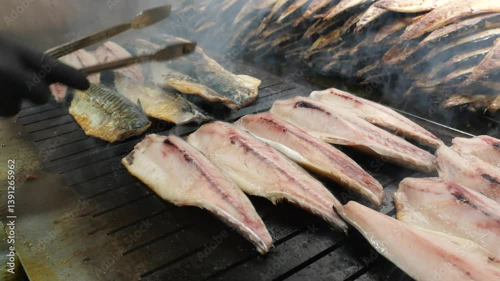 Grilling fresh fish with smoky flavor in bustling kitchen