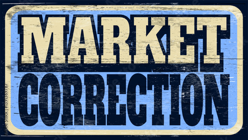 Aged and worn market correction sign on wood