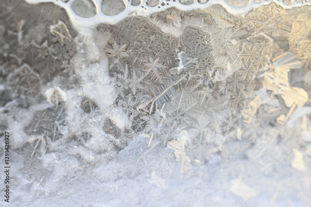 ice pattern on winter glass, abstract background on a cold sunny day