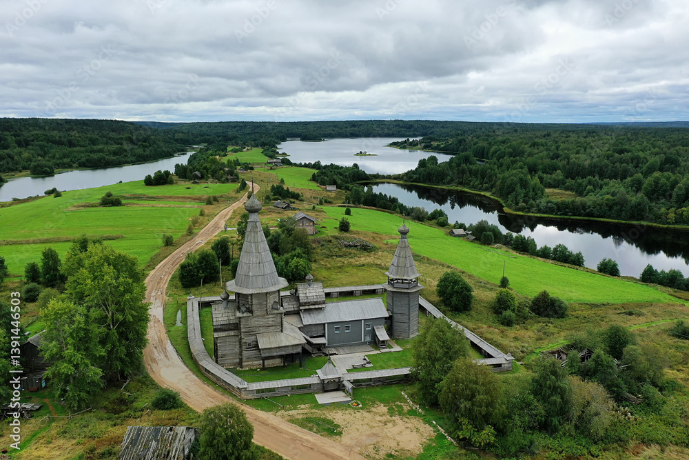 Fototapeta premium wooden church on the lake shore, drone photo, Kenozersky Park top view