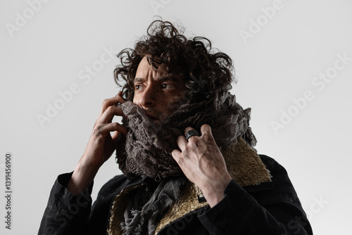 A dramatic hero from the post-apocalypse, a young man in mud and dirty clothes, wrapped in rags, expressive close-up portrait