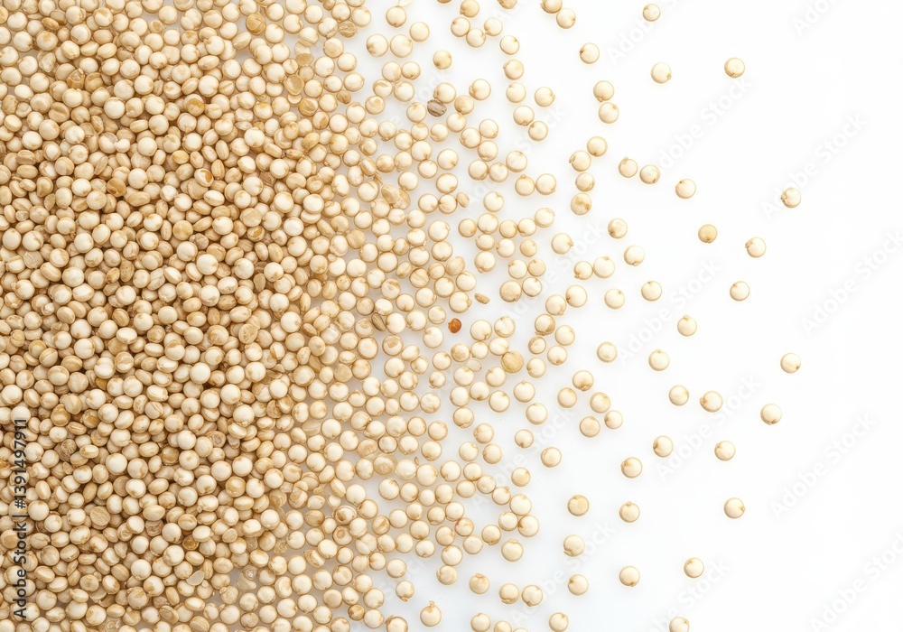 Close up view of a pile of quinoa seeds scattered on a white surface in a studio environment