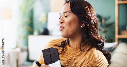 Foto Enjoying, chocolate and woman with snack, home and relax in living room with tasty treat and junk food