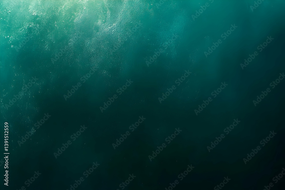 Fototapeta premium Underwater scene, dark teal water, light above.