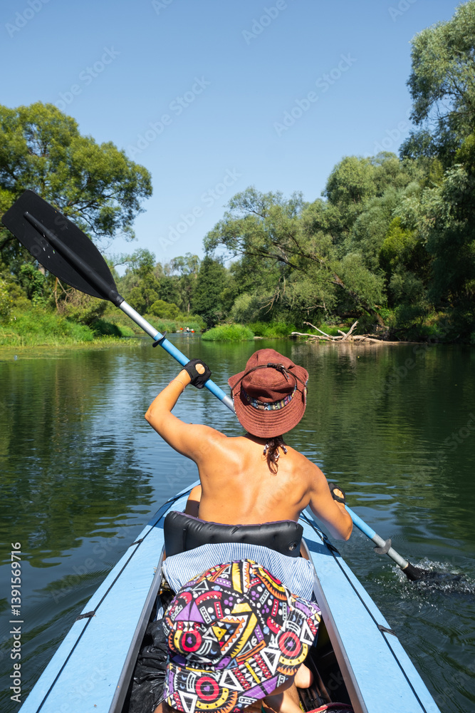 Family kayak trip. Mom and daughter rowing a boat on the river, a water hike, a summer adventure. Eco-friendly and extreme tourism, active and healthy lifestyle