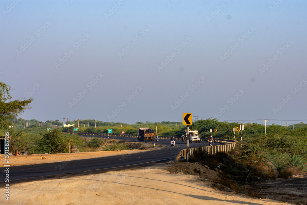 Light Traffic of Loaded Trucks on Highway Through Desert at Rann of Kutch