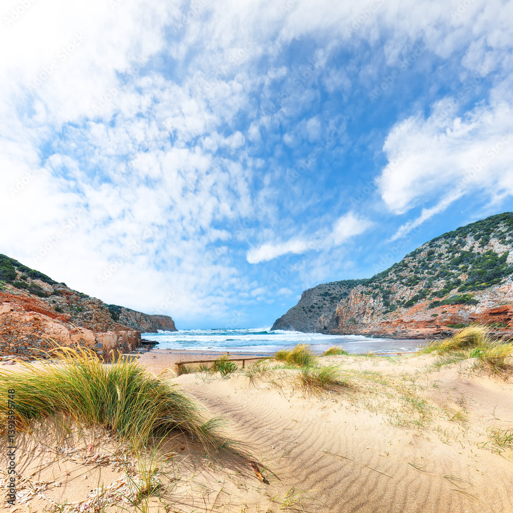 Attractive view of valley Cala Domestica with marvelous sand beach and ruines of old village