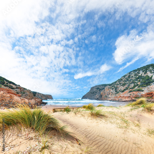 Attractive view of valley Cala Domestica  with marvelous sand beach and ruines of old village