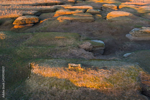 Lone wooden bench overlooking the Kostivere karst landscape during golden hour in Estonia. photo