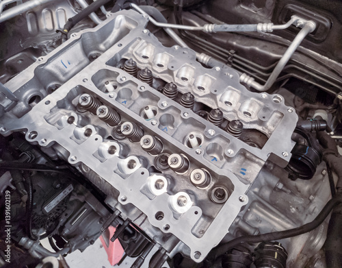 The petrol engine is being overhauled, the camshaft and spark plug assembly can be seen