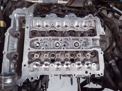 The petrol engine is being overhauled, the camshaft and spark plug assembly can be seen