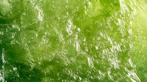Close-up of a green, viscous, textured substance with air bubbles.